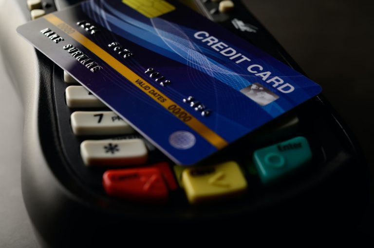 Credit card laying on swipe machine.